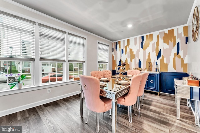 dining space with hardwood / wood-style floors and ornamental molding