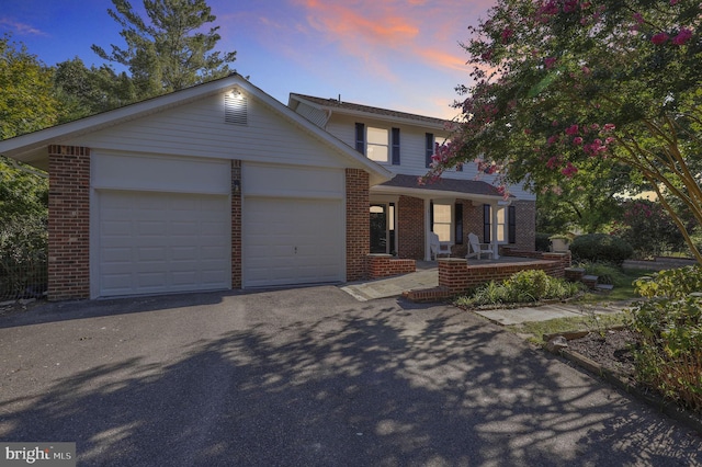 view of front of property featuring a porch and a garage