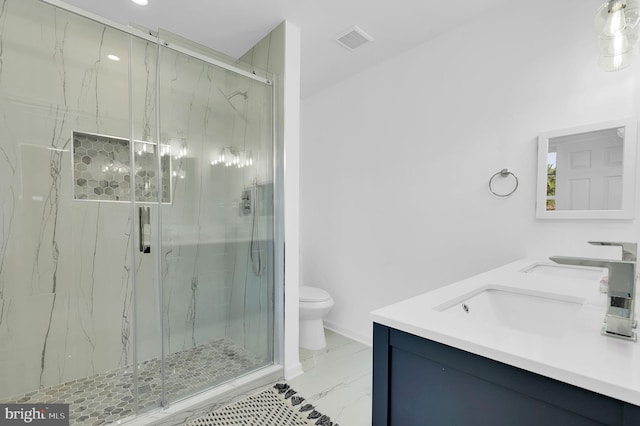 bathroom with an enclosed shower, vanity, and toilet