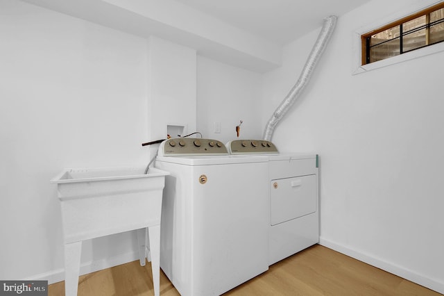 laundry area featuring light wood-type flooring and washing machine and clothes dryer