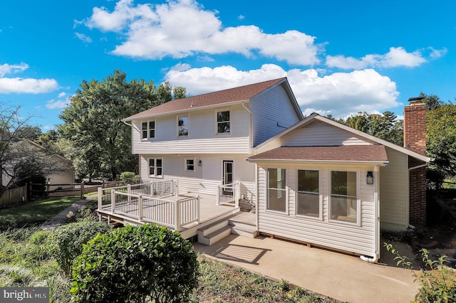 rear view of house with a wooden deck