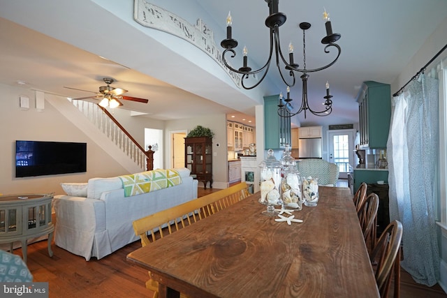 dining area with dark hardwood / wood-style flooring and ceiling fan with notable chandelier