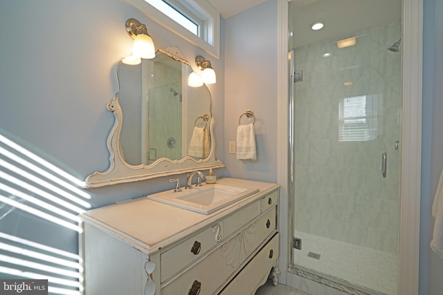 bathroom with a shower with door and vanity