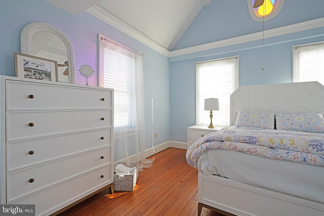 bedroom featuring crown molding, vaulted ceiling, and hardwood / wood-style floors