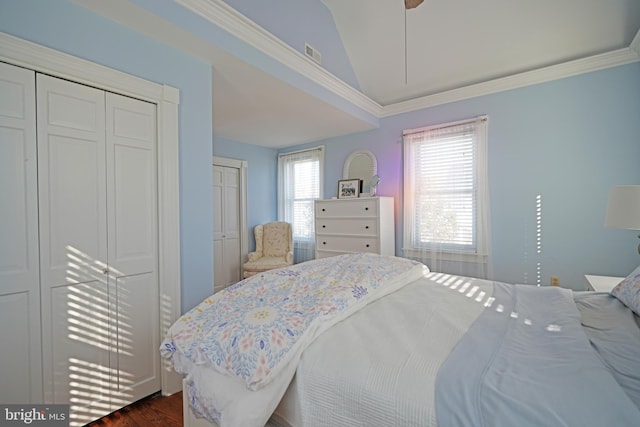 bedroom with ornamental molding, lofted ceiling, and dark wood-type flooring