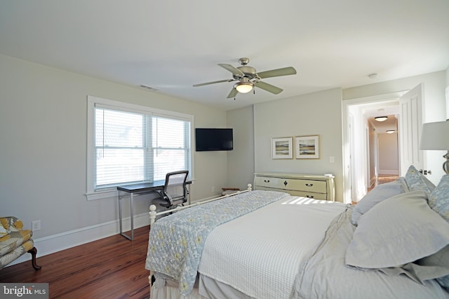 bedroom with dark hardwood / wood-style floors and ceiling fan