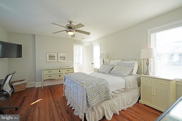 bedroom with dark hardwood / wood-style floors and ceiling fan