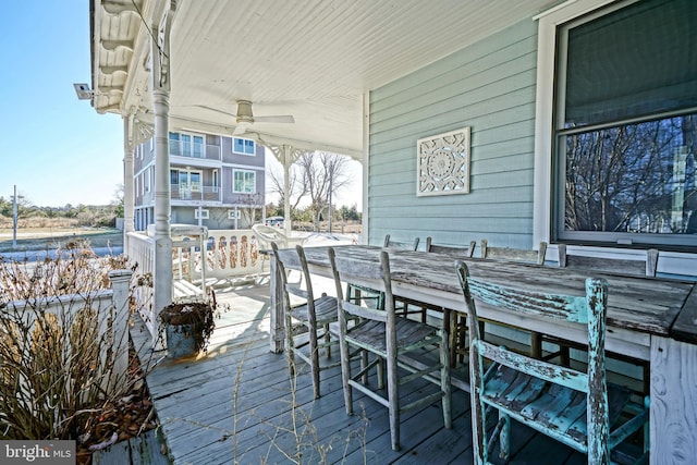 deck featuring exterior bar and ceiling fan