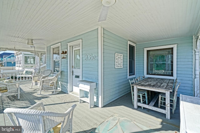 wooden terrace with a porch and ceiling fan