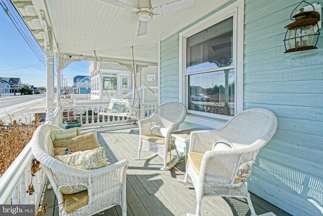 wooden deck with ceiling fan and covered porch