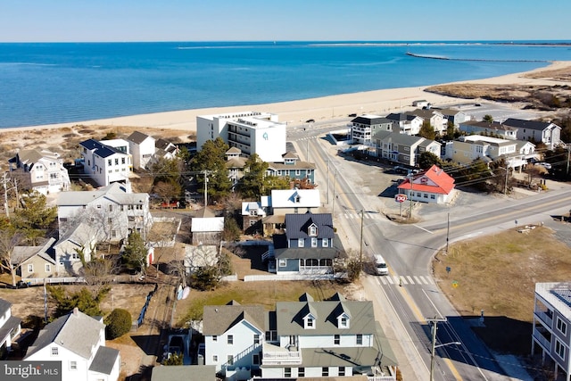 bird's eye view with a water view and a beach view