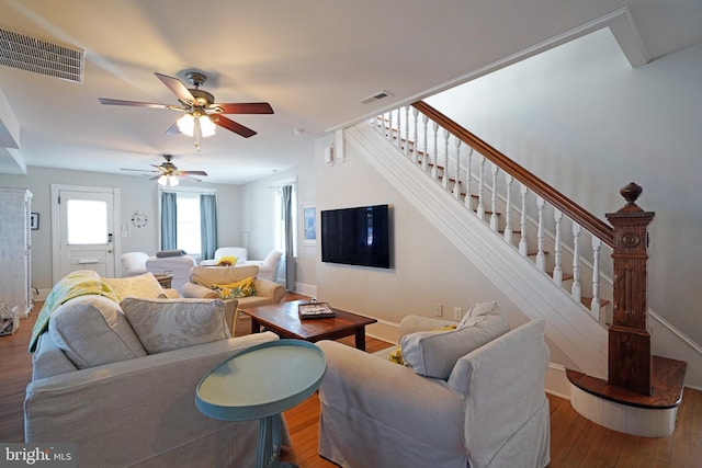 living room with ceiling fan and hardwood / wood-style floors