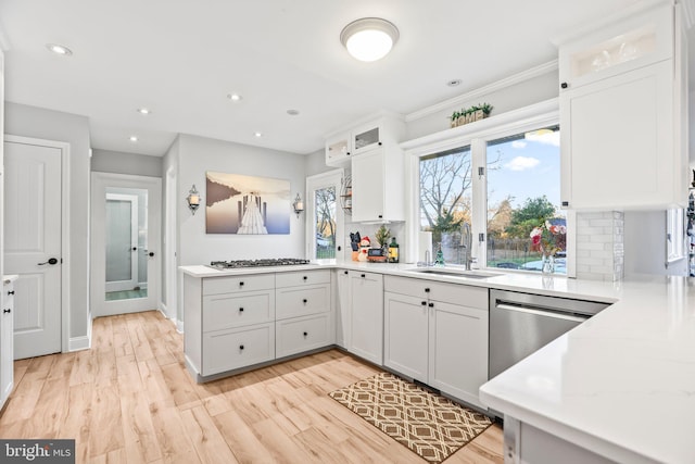 kitchen featuring decorative backsplash, sink, and white cabinets