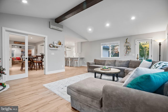 living room with a wall mounted air conditioner, lofted ceiling with beams, and light hardwood / wood-style flooring