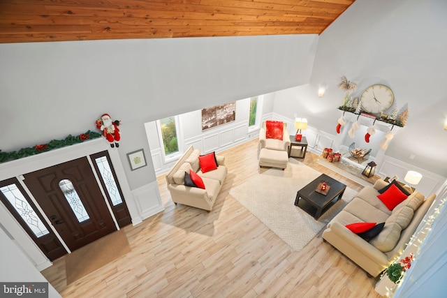 living room with light wood-type flooring, high vaulted ceiling, and wood ceiling