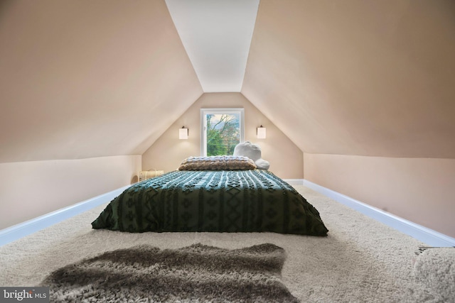 carpeted bedroom featuring vaulted ceiling