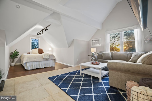 tiled bedroom with a wall mounted air conditioner, track lighting, and vaulted ceiling