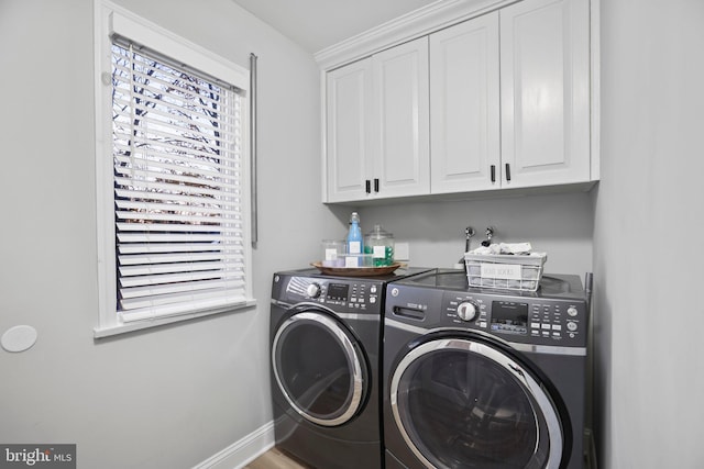 laundry room featuring cabinets and washing machine and clothes dryer