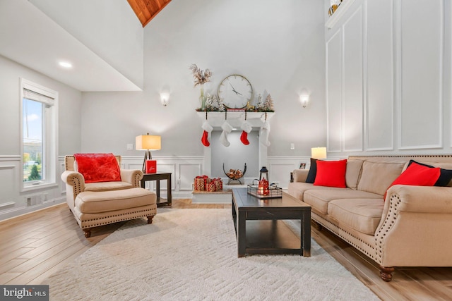 living room featuring lofted ceiling and light wood-type flooring