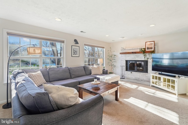 living room with a textured ceiling and light colored carpet