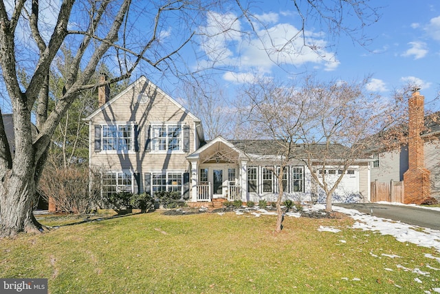 view of front of home featuring a front yard and a garage