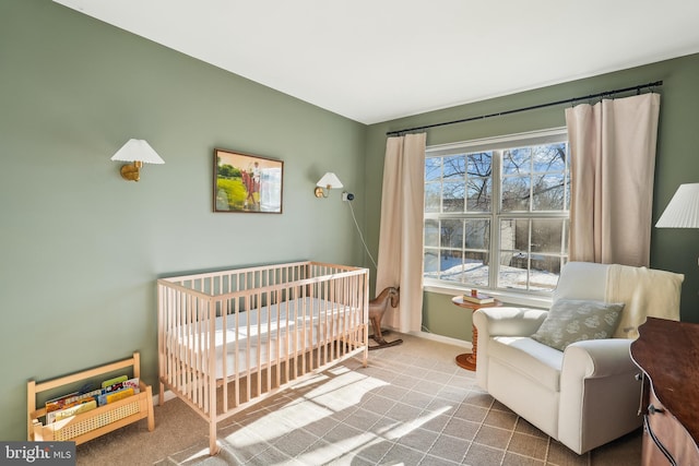 carpeted bedroom featuring a crib