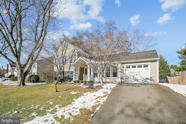 front facade featuring a porch, a front lawn, and a garage