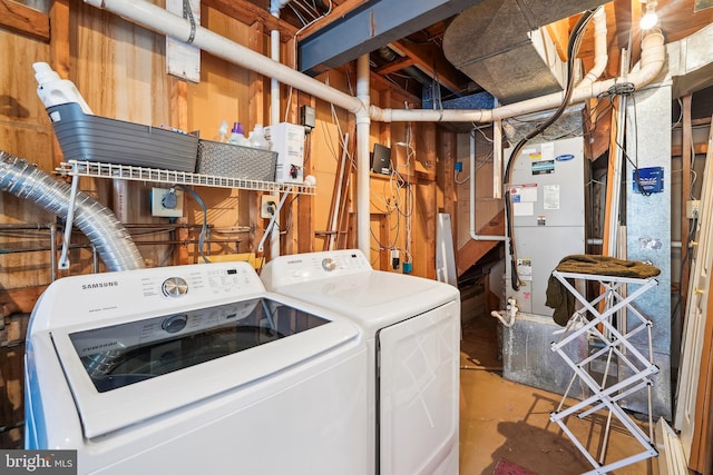 clothes washing area with washer and dryer and heating unit