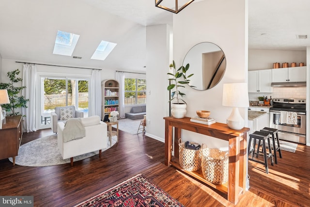 living room featuring dark hardwood / wood-style flooring and vaulted ceiling