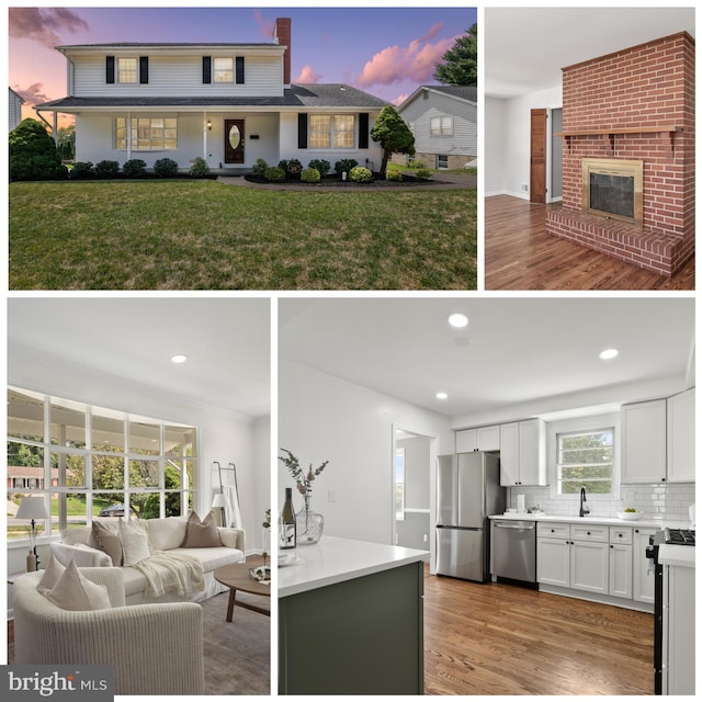 kitchen with white cabinetry, stainless steel appliances, hardwood / wood-style floors, decorative backsplash, and a fireplace