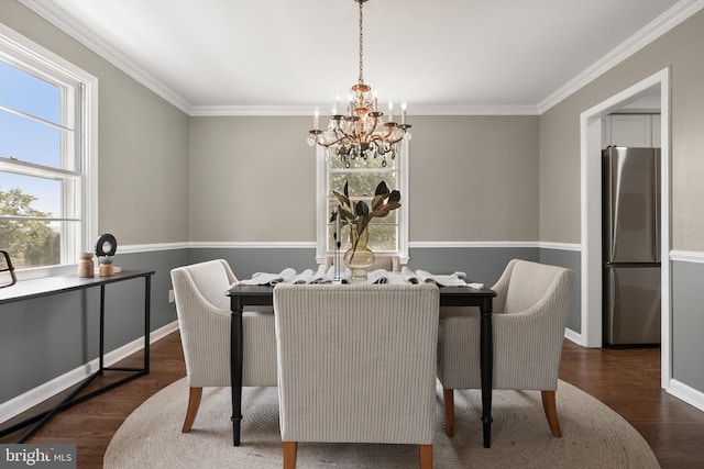 dining room featuring crown molding, dark hardwood / wood-style flooring, and a chandelier