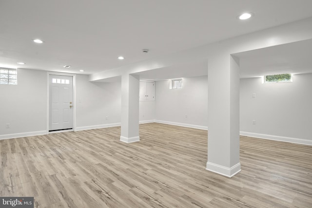 basement with light hardwood / wood-style flooring