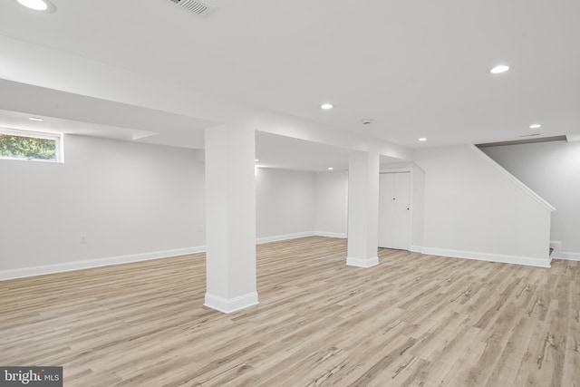 basement with light hardwood / wood-style floors