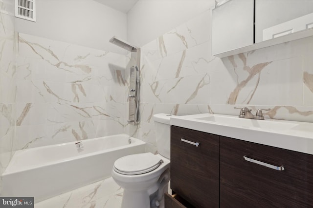 full bathroom with vanity, toilet, tiled shower / bath, and tile walls