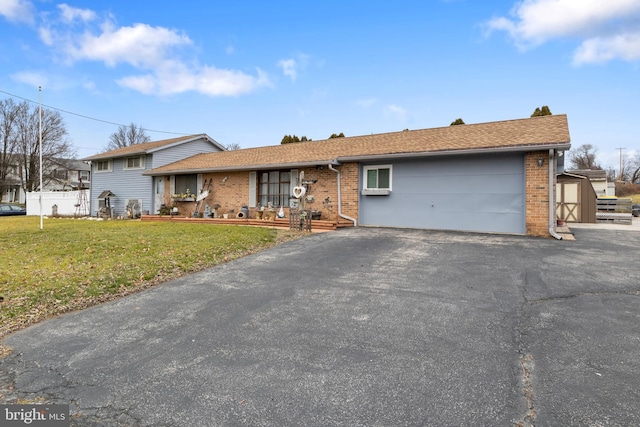 single story home with a front yard and a storage shed