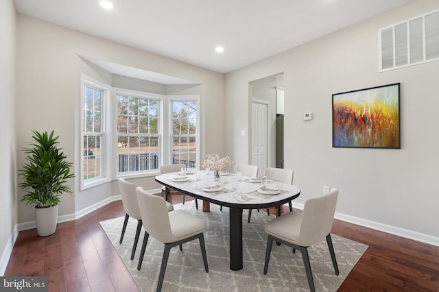 dining space with a healthy amount of sunlight and dark wood-type flooring