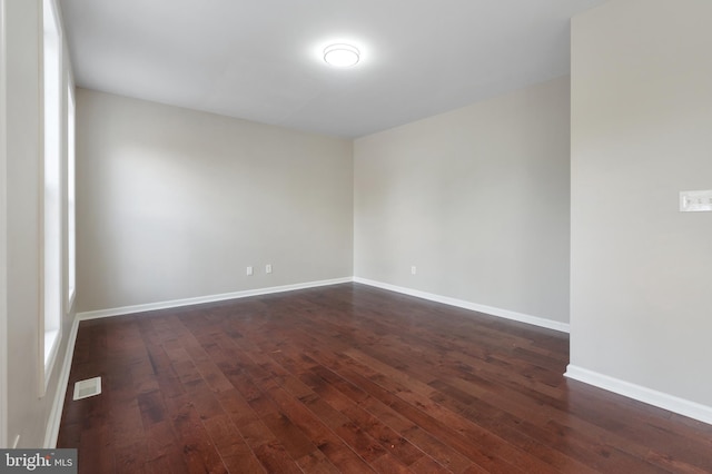 empty room featuring dark hardwood / wood-style floors