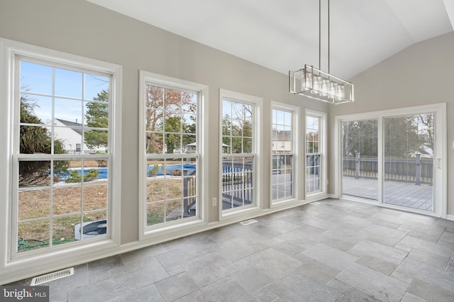 unfurnished sunroom with lofted ceiling