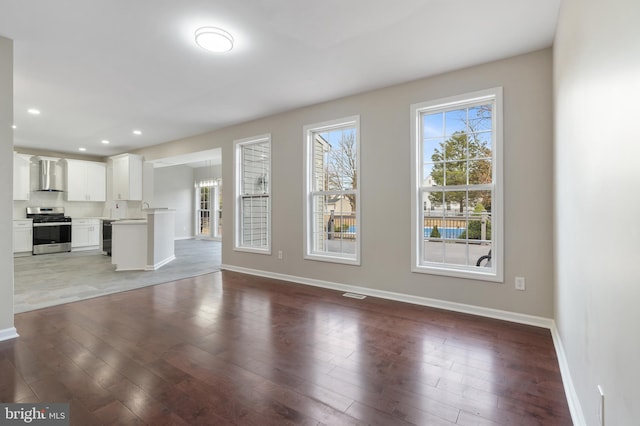 unfurnished living room featuring wine cooler and dark wood-type flooring