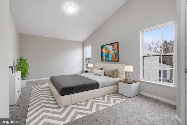 bedroom featuring light colored carpet and high vaulted ceiling