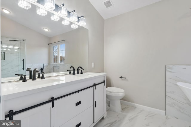 bathroom with vanity, toilet, and a shower with door