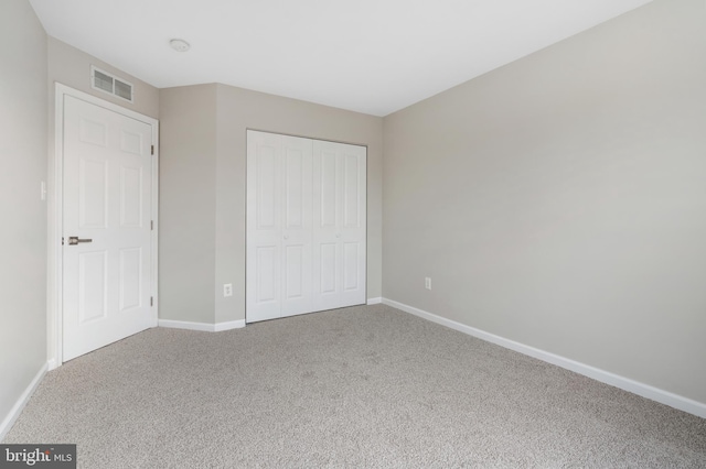 unfurnished bedroom with carpet floors and a closet