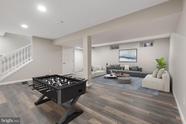 playroom featuring dark wood-type flooring