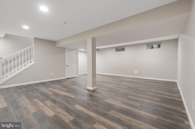 basement with dark hardwood / wood-style flooring