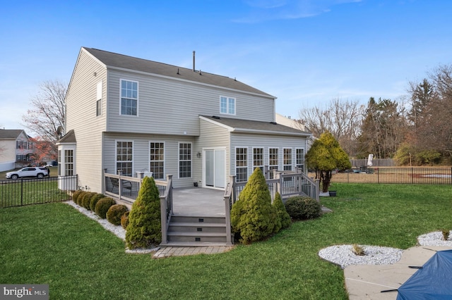 rear view of property featuring a yard and a wooden deck