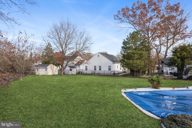 view of yard featuring an outdoor structure and a covered pool