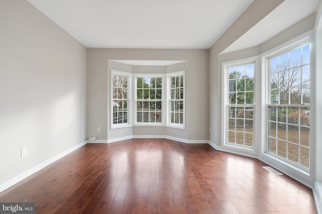 spare room with dark hardwood / wood-style floors