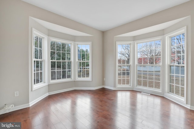 unfurnished dining area featuring hardwood / wood-style floors