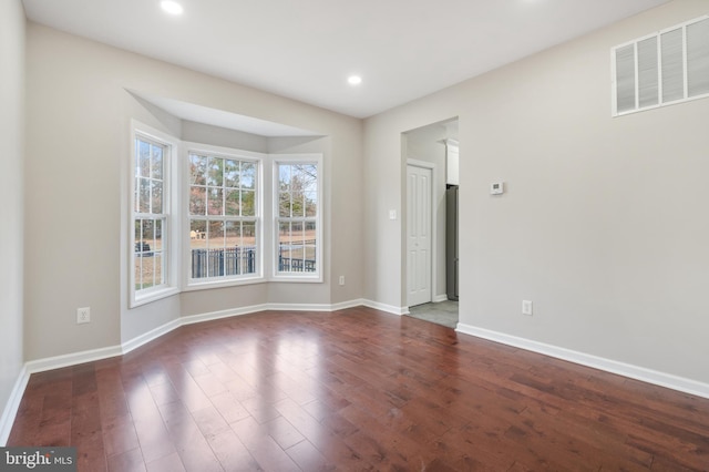 unfurnished room featuring dark wood-type flooring