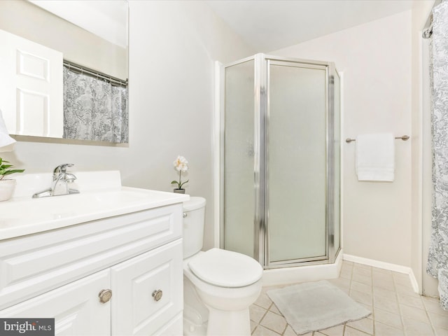 bathroom with tile patterned floors, vanity, toilet, and a shower